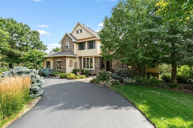 2255 Chelmsford Ln, Saint Cloud, MN 56301 - view of front of property with stone siding, stucco siding, and a front yard