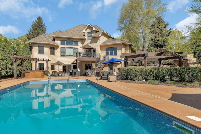 2255 Chelmsford Ln, Saint Cloud, MN 56301 - view of swimming pool featuring a hot tub, a pergola, stairway, a patio area, and a deck