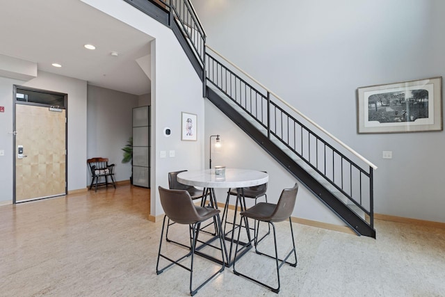 dining room with stairway, baseboards, and recessed lighting
