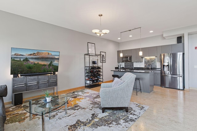 living room with recessed lighting, light wood-style floors, and a chandelier