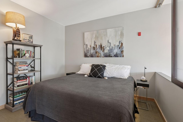 carpeted bedroom with baseboards