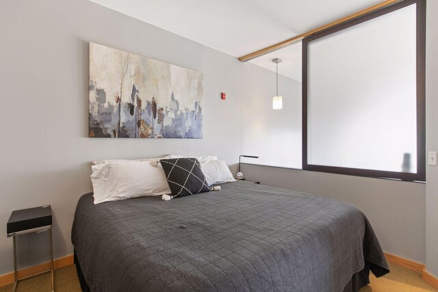bedroom featuring carpet and baseboards