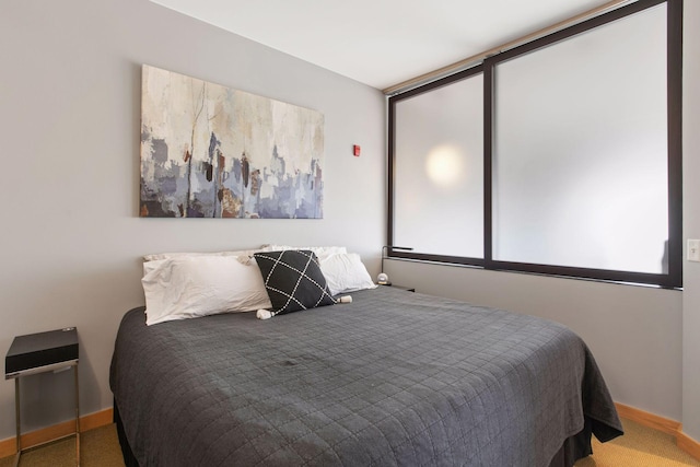 bedroom with carpet floors and baseboards