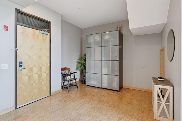 interior space featuring baseboards and wood finished floors