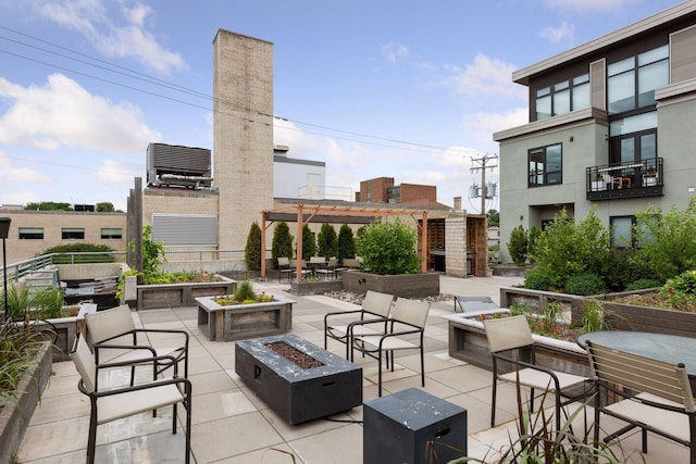 view of patio with a fire pit, cooling unit, and a pergola