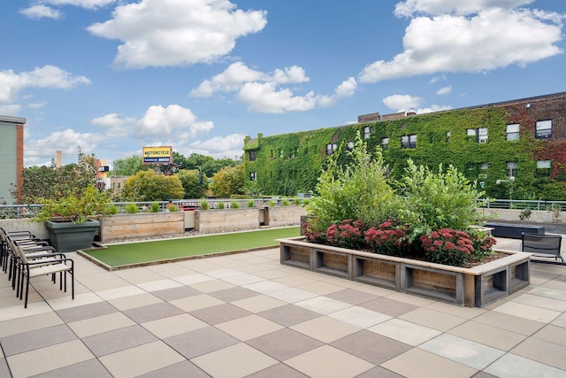 view of patio / terrace featuring a game area and fence