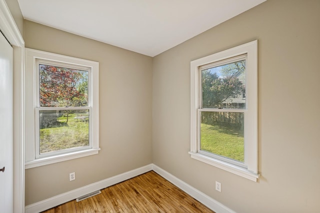 2647 Abbott Ave N, Robbinsdale, MN 55422 - spare room featuring plenty of natural light, baseboards, and wood finished floors