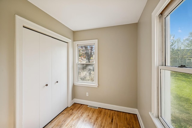 2647 Abbott Ave N, Robbinsdale, MN 55422 - unfurnished bedroom with baseboards, light wood-style floors, and a closet