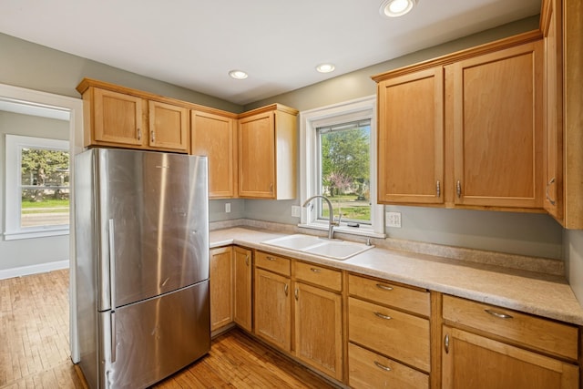 2647 Abbott Ave N, Robbinsdale, MN 55422 - kitchen with freestanding refrigerator, a sink, light countertops, light wood finished floors, and recessed lighting