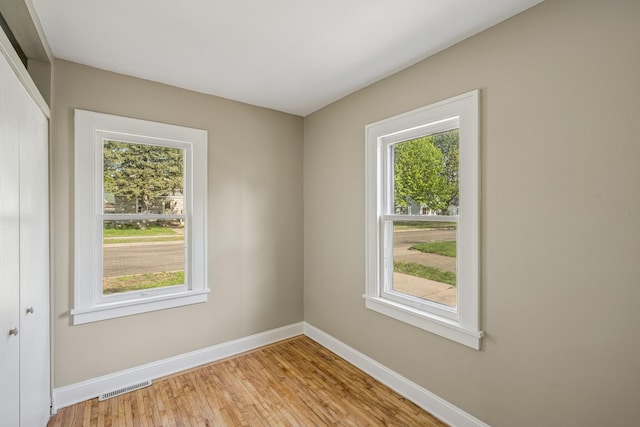 2647 Abbott Ave N, Robbinsdale, MN 55422 - unfurnished room featuring healthy amount of natural light, light wood finished floors, and baseboards