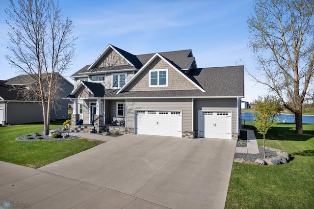 craftsman inspired home with a front yard, concrete driveway, stone siding, an attached garage, and roof with shingles