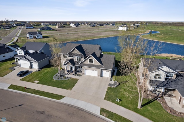 aerial view of residential area featuring a nearby body of water