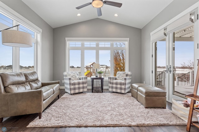living room featuring healthy amount of natural light, ceiling fan, vaulted ceiling, recessed lighting, and wood finished floors