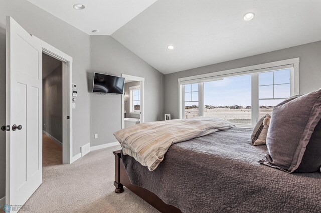 bedroom with light carpet, lofted ceiling, recessed lighting, baseboards, and ensuite bath