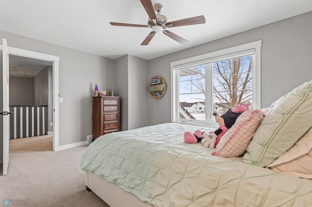 carpeted bedroom featuring baseboards and a ceiling fan