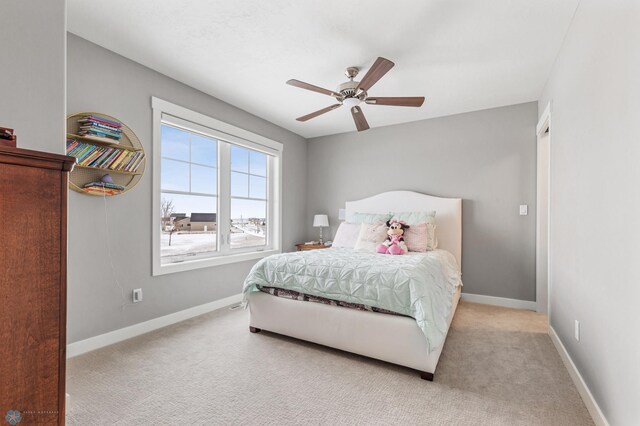carpeted bedroom featuring baseboards and ceiling fan
