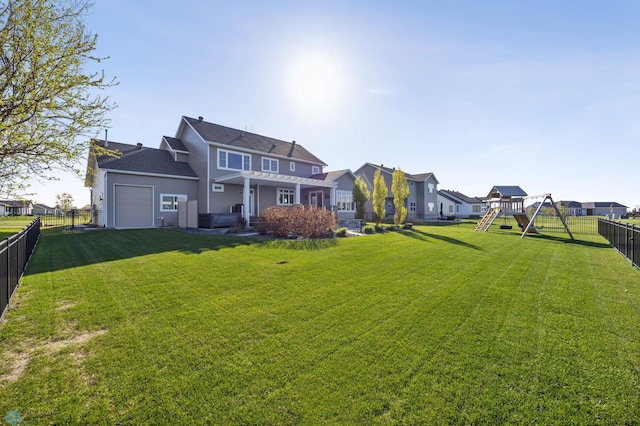rear view of property with a playground, a residential view, and an attached garage