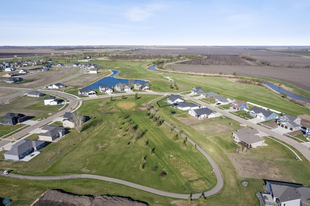 aerial view of property and surrounding area with a large body of water, nearby suburban area, and a golf course