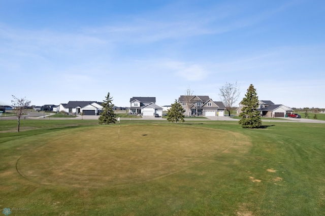 view of property's community with a residential view and a lawn