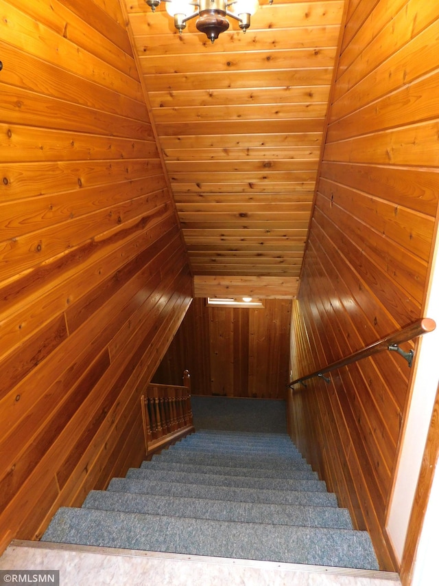 32598 Pioneer Ave, Aitkin, MN 56431 - staircase featuring wood walls, a chandelier, and wooden ceiling