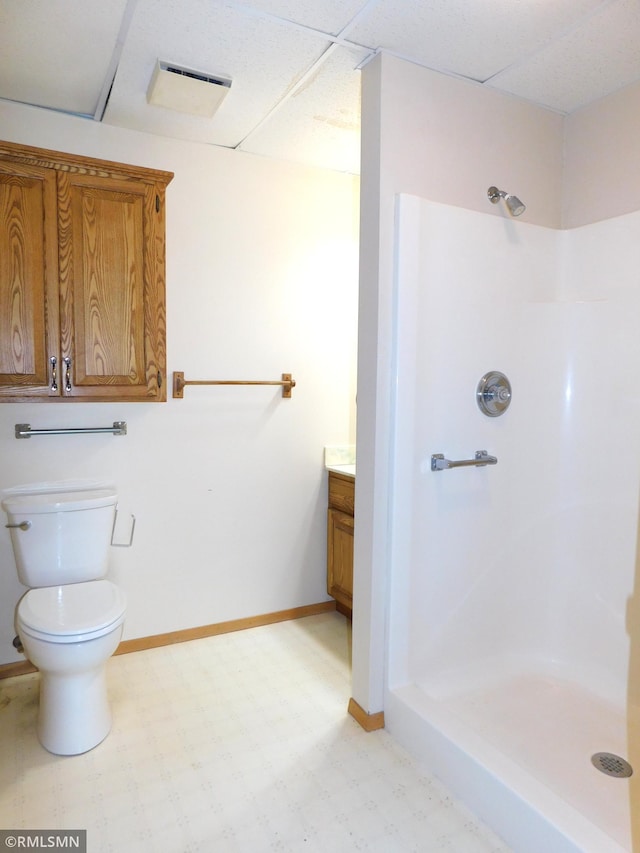 32598 Pioneer Ave, Aitkin, MN 56431 - bathroom featuring vanity, tile patterned floors, toilet, a shower, and baseboards
