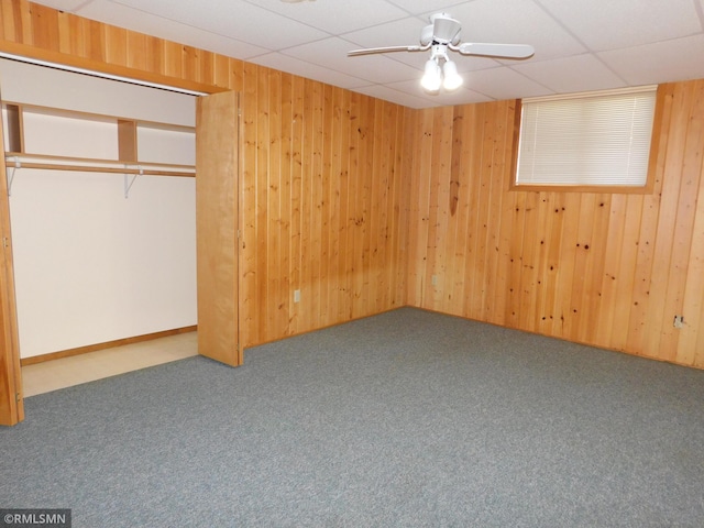 32598 Pioneer Ave, Aitkin, MN 56431 - unfurnished bedroom featuring carpet, wooden walls, ceiling fan, and a closet