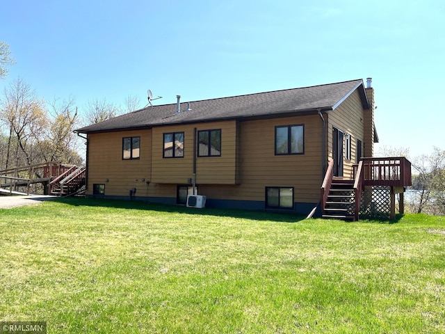 32598 Pioneer Ave, Aitkin, MN 56431 - rear view of property featuring stairway, a deck, a yard, and a chimney