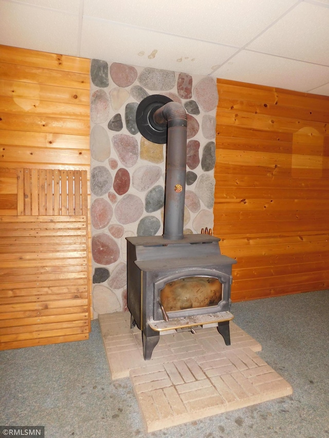32598 Pioneer Ave, Aitkin, MN 56431 - detailed view of a wood stove, carpet flooring, and wooden walls