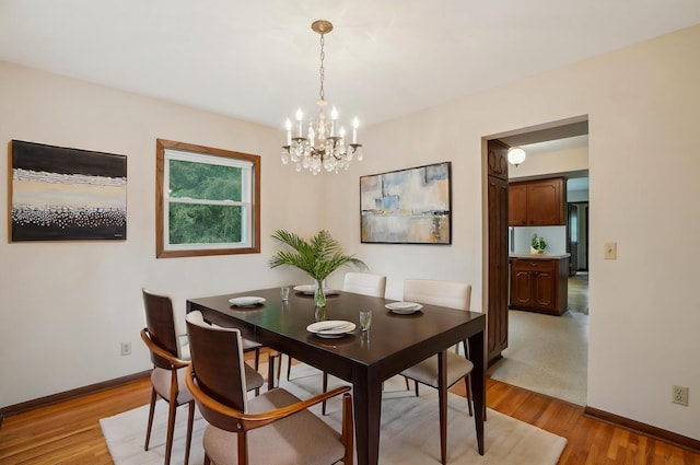 3529 Jerry St, White Bear Lake, MN 55110 - dining area featuring light wood-style flooring, a chandelier, and baseboards