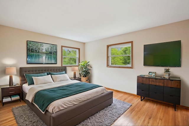 3529 Jerry St, White Bear Lake, MN 55110 - bedroom featuring multiple windows, light wood finished floors, and baseboards