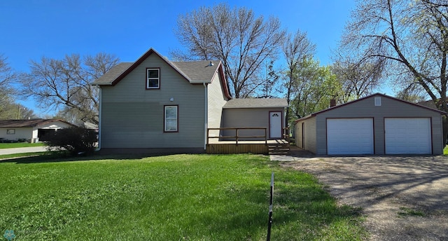 304 1st Ave E, Halstad, MN 56548 - view of front of home with a garage, an outbuilding, a front lawn, and a shingled roof