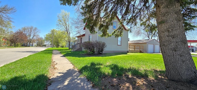 304 1st Ave E, Halstad, MN 56548 - view of side of property with a yard, an outbuilding, and a detached garage