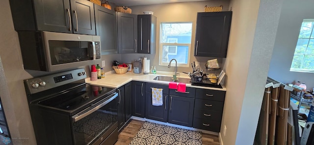 304 1st Ave E, Halstad, MN 56548 - kitchen featuring stainless steel appliances, a sink, wood finished floors, and light countertops