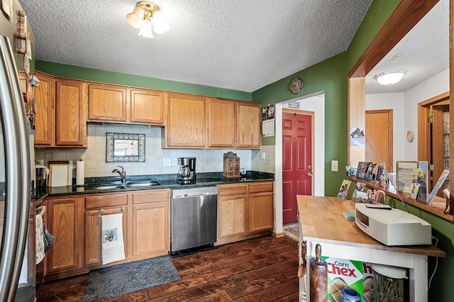 2231 Penn Pl Unit 114, North Saint Paul, MN 55109 - kitchen featuring stainless steel appliances, a sink, dark wood-type flooring, a textured ceiling, and backsplash