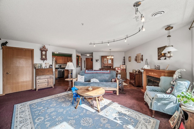 2231 Penn Pl Unit 114, North Saint Paul, MN 55109 - living area with carpet floors, a textured ceiling, and track lighting