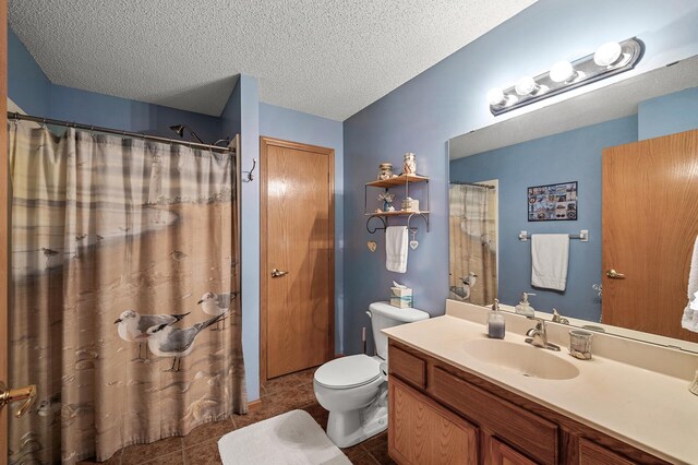 2231 Penn Pl Unit 114, North Saint Paul, MN 55109 - full bathroom featuring tile patterned floors, vanity, toilet, and a textured ceiling