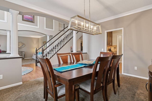 13148 Crolly Ct, Rosemount, MN 55068 - carpeted dining area with ornate columns, crown molding, baseboards, arched walkways, and stairway