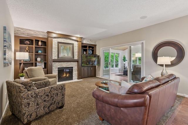 13148 Crolly Ct, Rosemount, MN 55068 - living area with a textured ceiling, a stone fireplace, baseboards, built in shelves, and wood finished floors