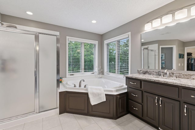 13148 Crolly Ct, Rosemount, MN 55068 - bathroom with a shower stall, vanity, a bath, tile patterned floors, and a walk in closet