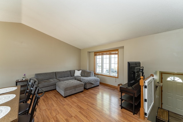 living area with lofted ceiling and light wood-style flooring