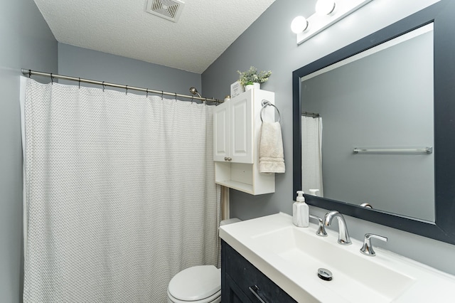 bathroom featuring toilet, a textured ceiling, vanity, and curtained shower