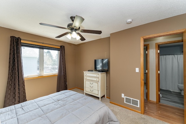 bedroom featuring baseboards, a textured ceiling, and a ceiling fan