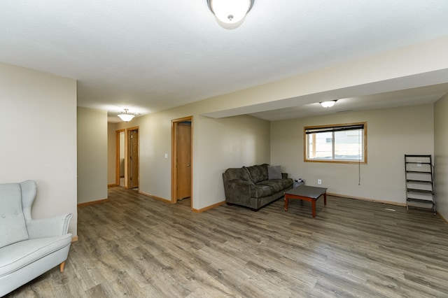living area featuring light wood-style floors and baseboards