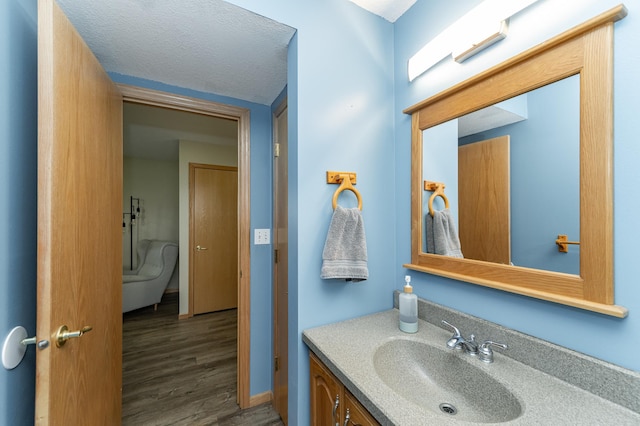 bathroom with wood finished floors and vanity
