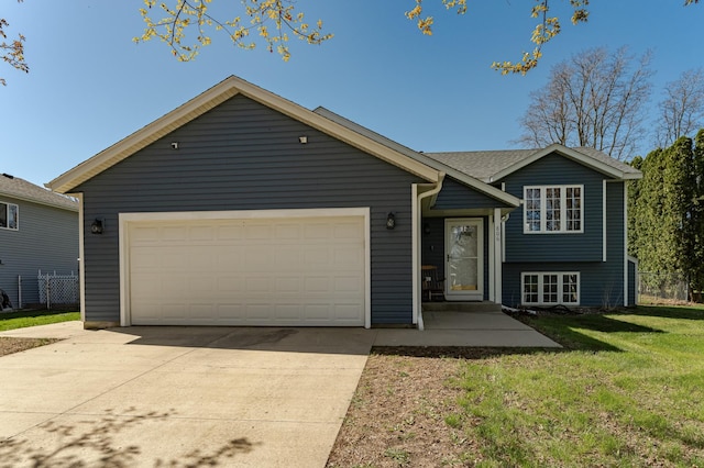 split level home with a garage and concrete driveway