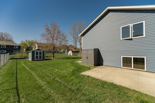 view of yard with a storage shed, a patio, and an outdoor structure