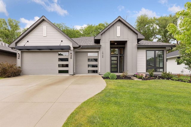 16798 Stirrup Ln, Eden Prairie, MN 55347 - view of front facade featuring board and batten siding, driveway, a garage, a front yard, and roof with shingles