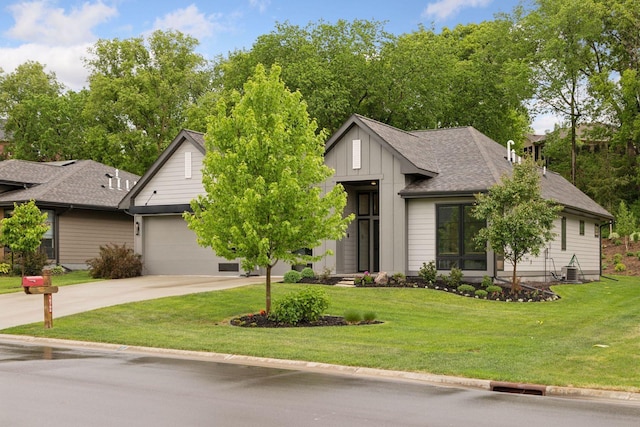 16798 Stirrup Ln, Eden Prairie, MN 55347 - view of front of property with concrete driveway, an attached garage, a front yard, and board and batten siding