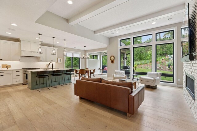16798 Stirrup Ln, Eden Prairie, MN 55347 - living area featuring light wood-style floors, a fireplace, recessed lighting, and beamed ceiling