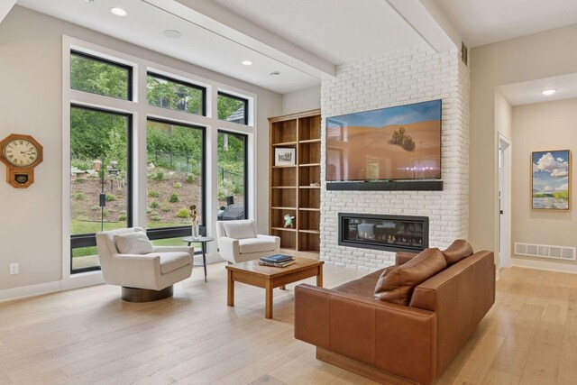 16798 Stirrup Ln, Eden Prairie, MN 55347 - living area with a fireplace, light wood-style floors, recessed lighting, baseboards, and beamed ceiling